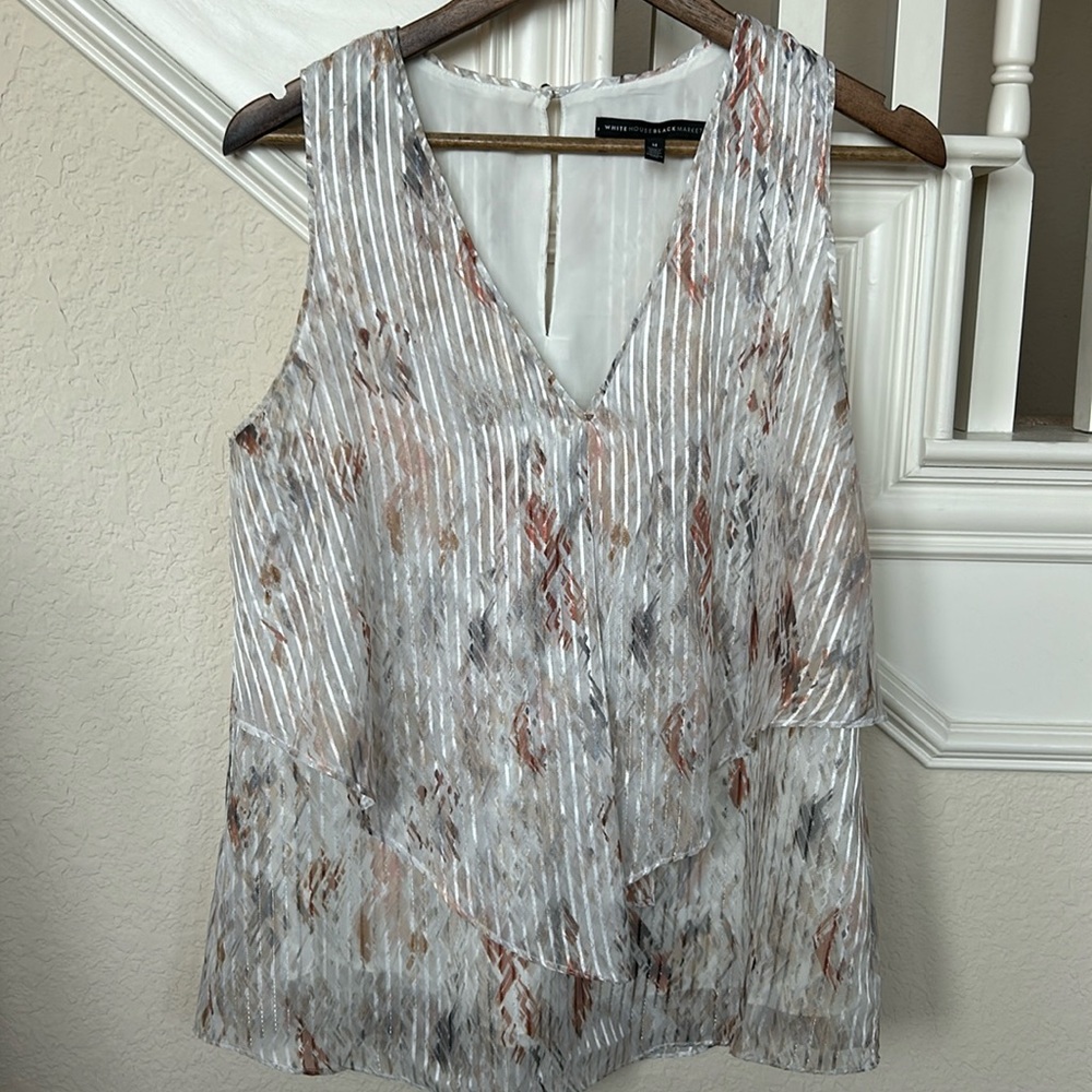 Sleeveless top with shell. Button closure back. Cream w/ blue and terracotta.
